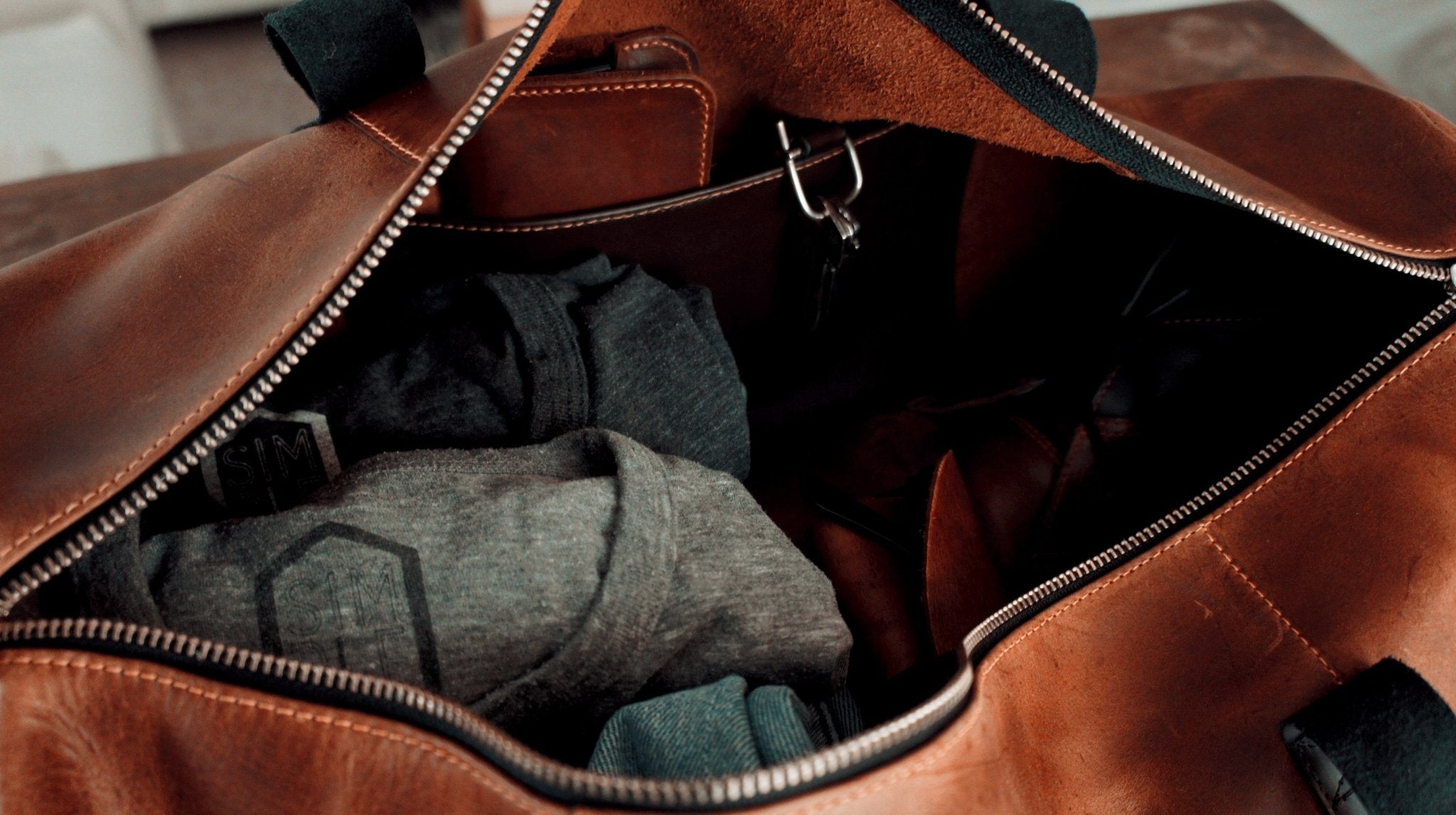 Simple Leather duffle bag, brown with black handles, inner pocket