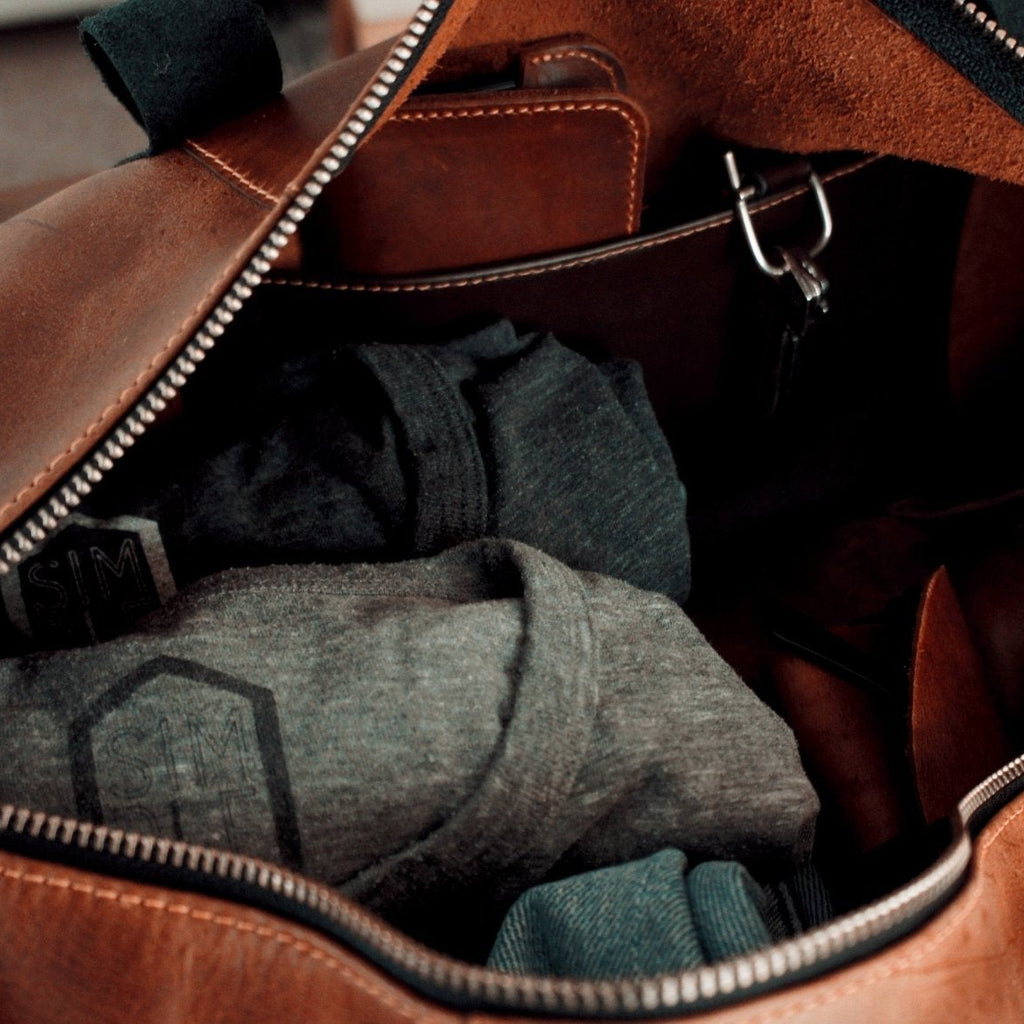 Simple Leather duffle bag, brown with black handles, inner pocket