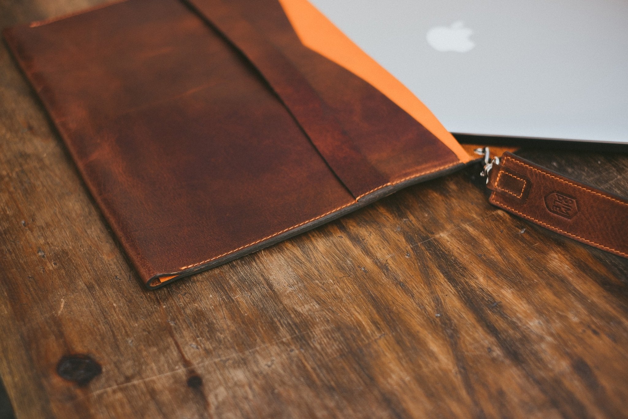 brown leather macbook pro sleeve, with shoulder strap, front side